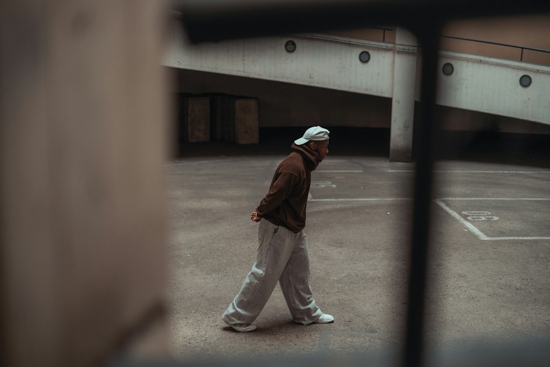 Man in casual clothing walking in an empty urban space