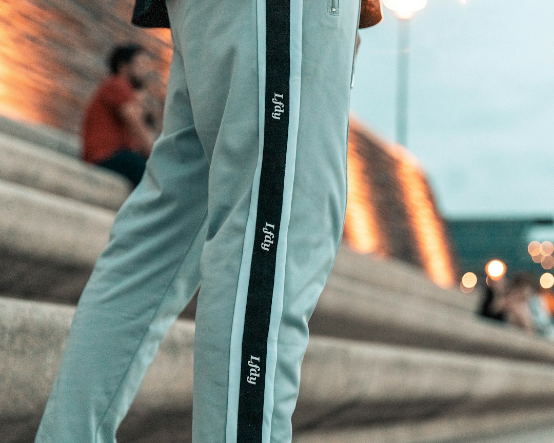 person in black and white long sleeve shirt and gray pants